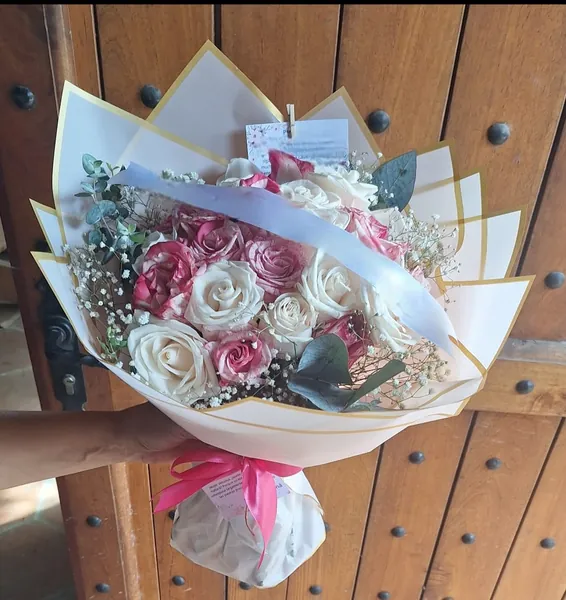 Ramo de rosas blancas y malva con envoltura rosa pálido