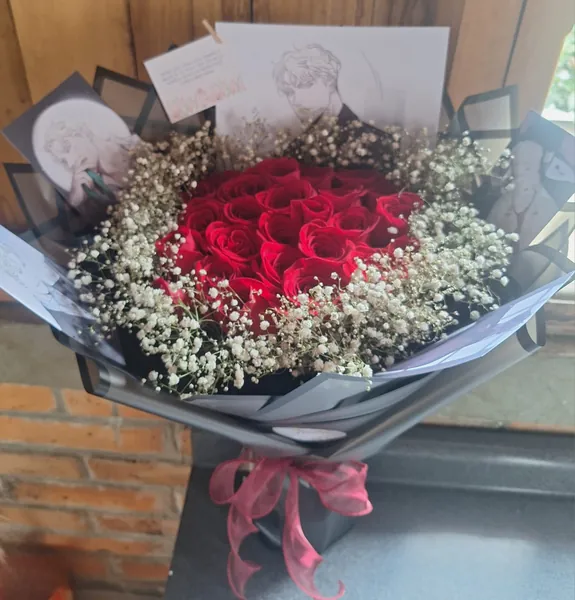 Ramo de rosas rojas con flor de nube y envoltura gris oscuro